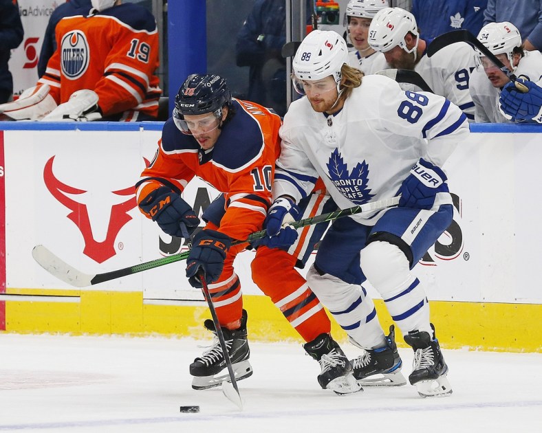 Mar 3, 2021; Edmonton, Alberta, CAN; Toronto Maple Leafs forward William Nylander (88) and Edmonton Oilers forward Joakim Nygard (10) battle for a loose puck during the first period at Rogers Place. Mandatory Credit: Perry Nelson-USA TODAY Sports