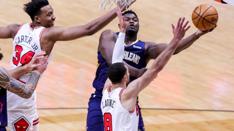 Mar 3, 2021; New Orleans, Louisiana, USA;  New Orleans Pelicans forward Zion Williamson (1) drives to the basket against Chicago Bulls guard Zach LaVine (8) and center Wendell Carter Jr. (34) during the first half at Smoothie King Center. Mandatory Credit: Stephen Lew-USA TODAY Sports
