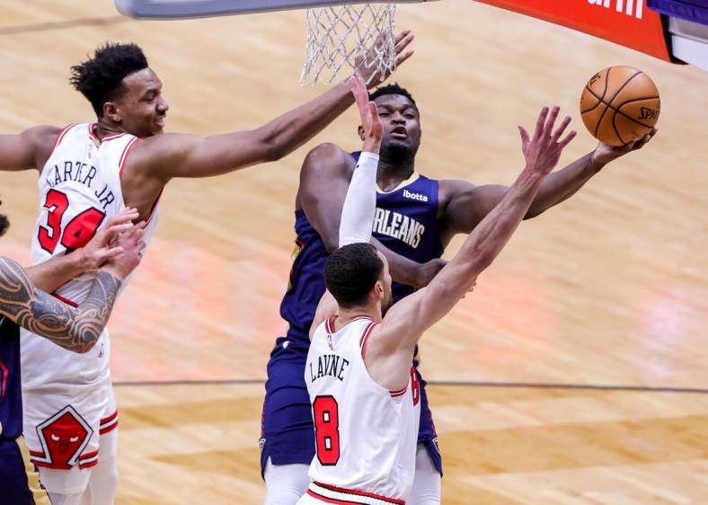 Mar 3, 2021; New Orleans, Louisiana, USA;  New Orleans Pelicans forward Zion Williamson (1) drives to the basket against Chicago Bulls guard Zach LaVine (8) and center Wendell Carter Jr. (34) during the first half at Smoothie King Center. Mandatory Credit: Stephen Lew-USA TODAY Sports