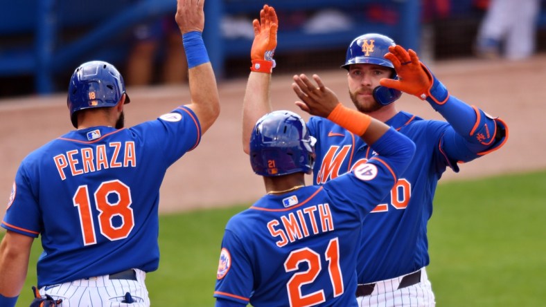 Mar 4, 2021; Port St. Lucie, Florida, USA; New York Mets first baseman Pete Alonso (20) is congratulated by Mallex Smith (21) and Jose Peraza (18) after hitting a grand slam home run against the Washington Nationals in the fifth inning of a spring training game at Clover Park. Mandatory Credit: Jim Rassol-USA TODAY Sports