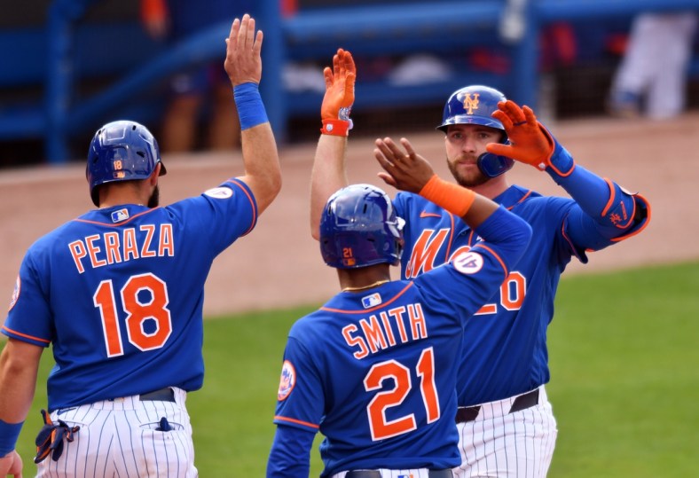 Mar 4, 2021; Port St. Lucie, Florida, USA; New York Mets first baseman Pete Alonso (20) is congratulated by Mallex Smith (21) and Jose Peraza (18) after hitting a grand slam home run against the Washington Nationals in the fifth inning of a spring training game at Clover Park. Mandatory Credit: Jim Rassol-USA TODAY Sports