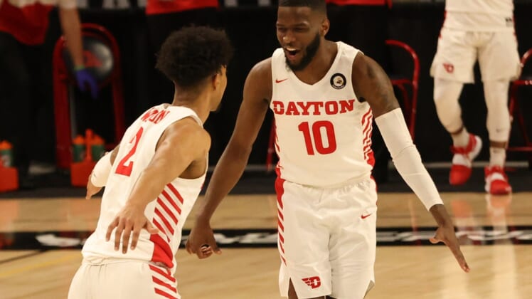 Mar 4, 2021; Richmond, Virginia, USA; Dayton Flyers guard Jalen Crutcher (10) celebrates on the court with Flyers guard Ibi Watson (2) against the Rhode Island Rams in the first half in the second round of the 2021 Atlantic 10 Conference Tournament at Stuart C. Siegel Center. Mandatory Credit: Geoff Burke-USA TODAY Sports