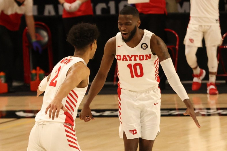 Mar 4, 2021; Richmond, Virginia, USA; Dayton Flyers guard Jalen Crutcher (10) celebrates on the court with Flyers guard Ibi Watson (2) against the Rhode Island Rams in the first half in the second round of the 2021 Atlantic 10 Conference Tournament at Stuart C. Siegel Center. Mandatory Credit: Geoff Burke-USA TODAY Sports