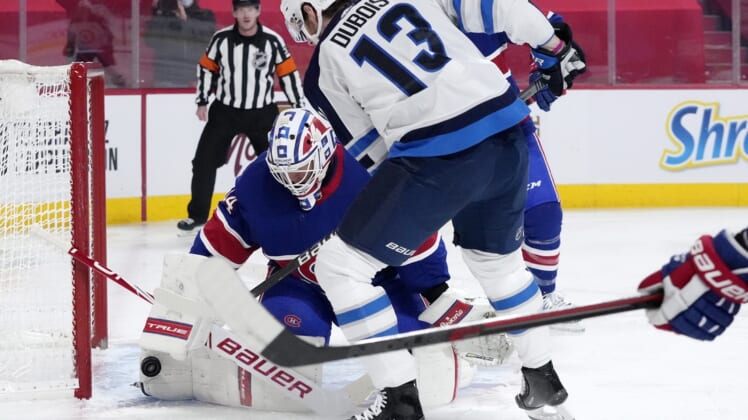 Mar 4, 2021; Montreal, Quebec, CAN; Montreal Canadiens goalie Jake Allen (34) stops a shot by Winnipeg Jets forward Pierre-Luc Dubois (13) during the first period at the Bell Centre. Mandatory Credit: Eric Bolte-USA TODAY Sports