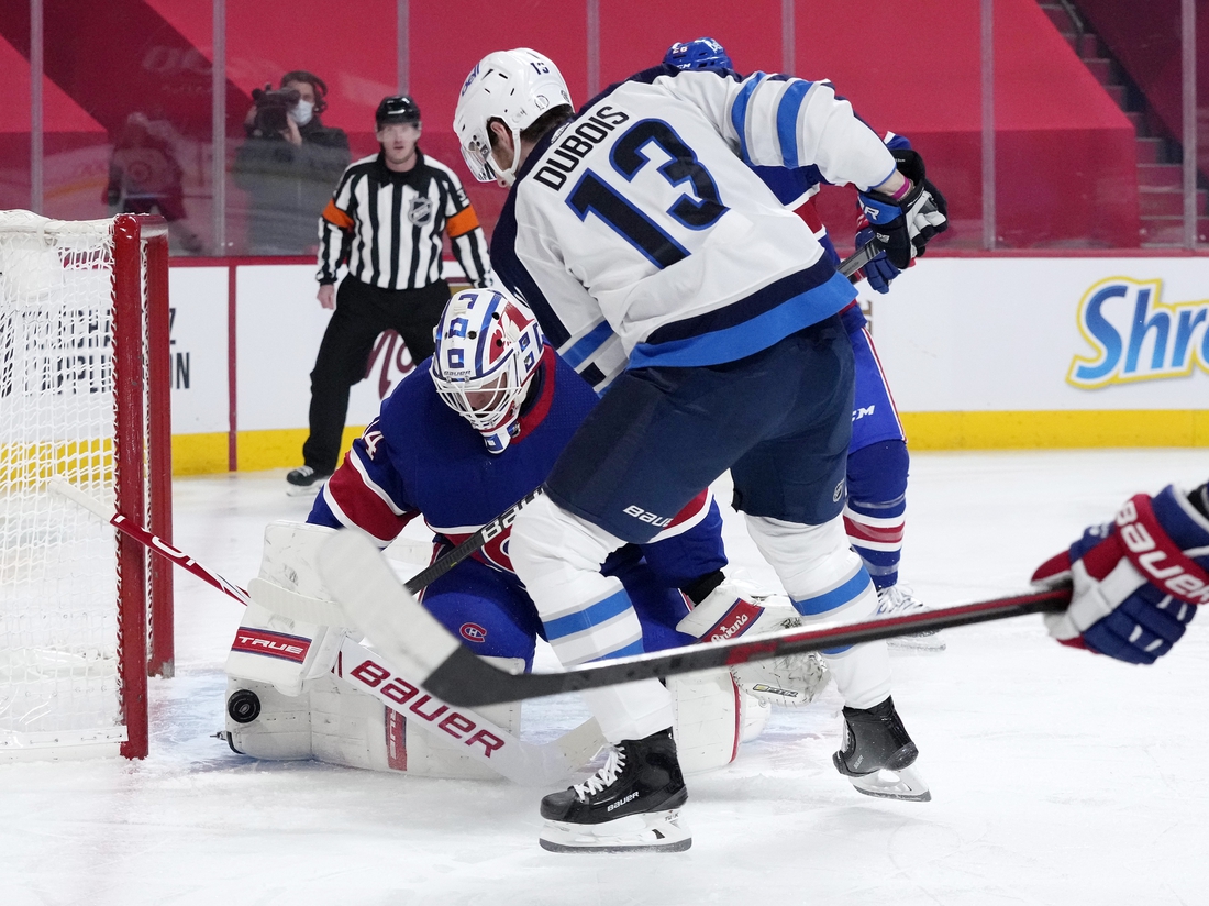 Mar 4, 2021; Montreal, Quebec, CAN; Montreal Canadiens goalie Jake Allen (34) stops a shot by Winnipeg Jets forward Pierre-Luc Dubois (13) during the first period at the Bell Centre. Mandatory Credit: Eric Bolte-USA TODAY Sports