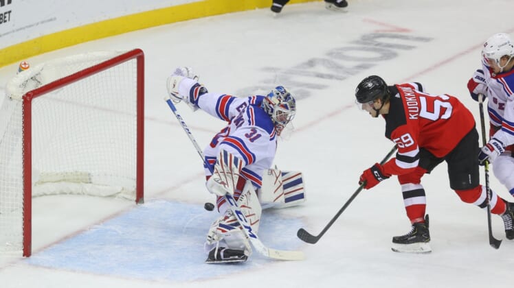 Mar 4, 2021; Newark, New Jersey, USA; New York Rangers goaltender Igor Shesterkin (31) makes a save on a shot by New Jersey Devils center Janne Kuokkanen (59) during the first period at Prudential Center. Mandatory Credit: Ed Mulholland-USA TODAY Sports