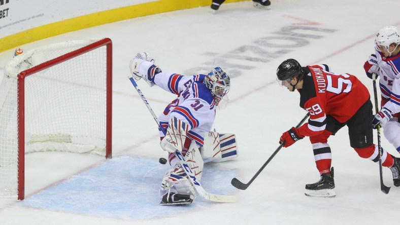 Mar 4, 2021; Newark, New Jersey, USA; New York Rangers goaltender Igor Shesterkin (31) makes a save on a shot by New Jersey Devils center Janne Kuokkanen (59) during the first period at Prudential Center. Mandatory Credit: Ed Mulholland-USA TODAY Sports