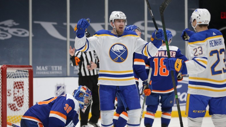 Mar 4, 2021; Uniondale, New York, USA; Buffalo Sabres defenseman Rasmus Ristolainen (55) celebrates with center Sam Reinhart (23) after scoring a goal against New York Islanders goalie Ilya Sorokin (30) during the third period at Nassau Veterans Memorial Coliseum. Mandatory Credit: Brad Penner-USA TODAY Sports