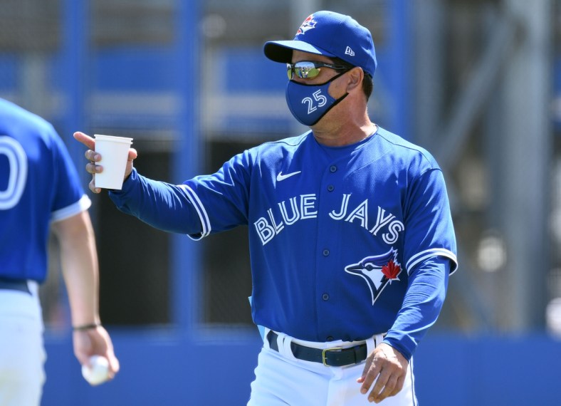 Mar 5, 2021; Dunedin, Florida, USA; Toronto Blue Jays manager Charlie Montoyo (25) watches his team warm up before the start of the game against the Baltimore Orioles during spring training at TD Ballpark. Mandatory Credit: Jonathan Dyer-USA TODAY Sports