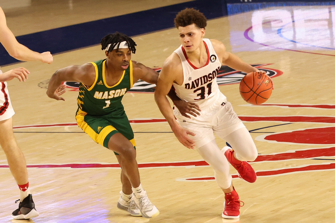 Mar 5, 2021; Richmond, Virginia, USA; Davidson Wildcats guard Kellan Grady (31) drives to the basket as George Mason Patriots guard Ronald Polite (1) defends in the second half of a quarterfinal in the Atlantic 10 conference tournament at Robins Center. Mandatory Credit: Geoff Burke-USA TODAY Sports