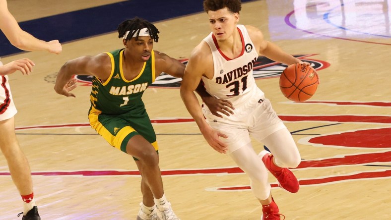 Mar 5, 2021; Richmond, Virginia, USA; Davidson Wildcats guard Kellan Grady (31) drives to the basket as George Mason Patriots guard Ronald Polite (1) defends in the second half of a quarterfinal in the Atlantic 10 conference tournament at Robins Center. Mandatory Credit: Geoff Burke-USA TODAY Sports