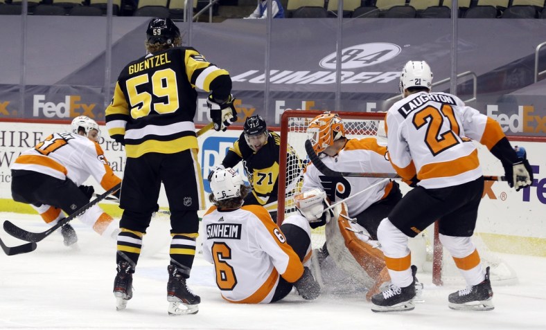 Mar 6, 2021; Pittsburgh, Pennsylvania, USA; Pittsburgh Penguins center Evgeni Malkin (71) scores a goal on a wrap around shot against Philadelphia Flyers goaltender Brian Elliott (37) during the first period at PPG Paints Arena. Mandatory Credit: Charles LeClaire-USA TODAY Sports