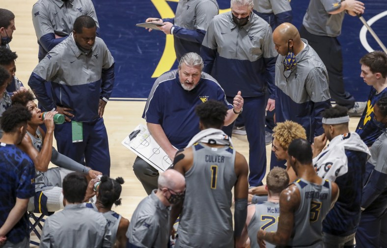 Mar 6, 2021; Morgantown, West Virginia, USA; West Virginia Mountaineers head coach Bob Huggins talks to his team during a timeout during the first half against the Oklahoma State Cowboys at WVU Coliseum. Mandatory Credit: Ben Queen-USA TODAY Sports