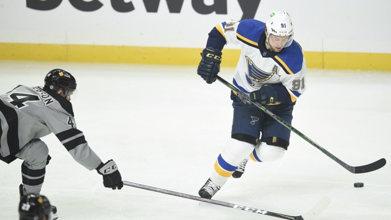 Mar 6, 2021; Los Angeles, California, USA; St. Louis Blues right wing Vladimir Tarasenko (91) handles the puck while Los Angeles Kings defenseman Mikey Anderson (44) defends during the second period at Staples Center. Mandatory Credit: Kelvin Kuo-USA TODAY Sports