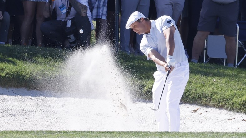 Mar 7, 2021; Orlando, Florida, USA; Bryson DeChambeau hits from a bunker near the fifth green after driving the lake during the final round of the Arnold Palmer Invitational golf tournament at Bay Hill Club & Lodge. Mandatory Credit: Reinhold Matay-USA TODAY Sports