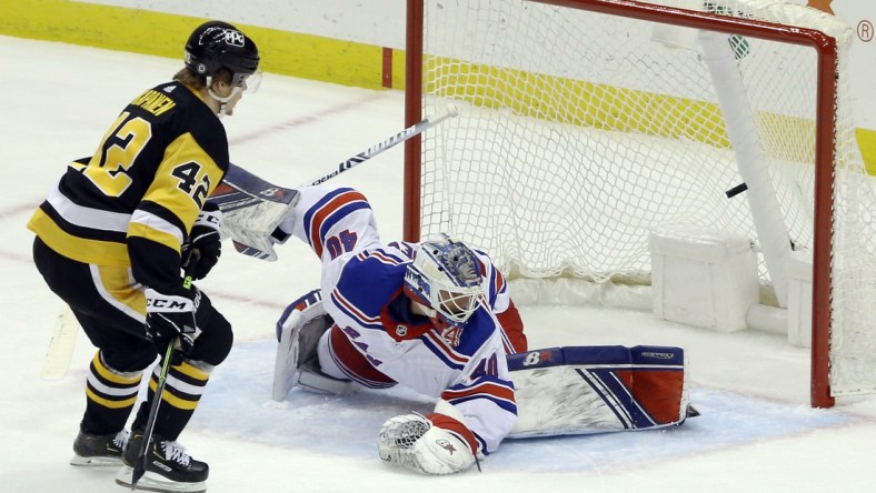 Mar 7, 2021; Pittsburgh, Pennsylvania, USA;  Pittsburgh Penguins right wing Kasperi Kapanen (42) scores a goal against New York Rangers goaltender Alexandar Georgiev (40) during the first period at PPG Paints Arena. Mandatory Credit: Charles LeClaire-USA TODAY Sports