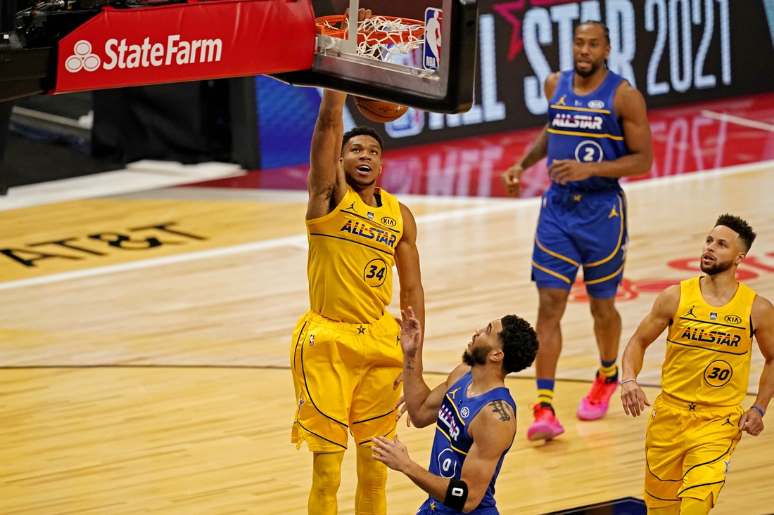 Mar 7, 2021; Atlanta, Georgia, USA;  Team LeBron forward Giannis Antetokounmpo of the Milwaukee Bucks (34)  dunks the ball against Team Durant forward Jayson Tatum of the Boston Celtics (0) during the 2021 NBA All-Star Game at State Farm Arena. Mandatory Credit: Dale Zanine-USA TODAY Sports