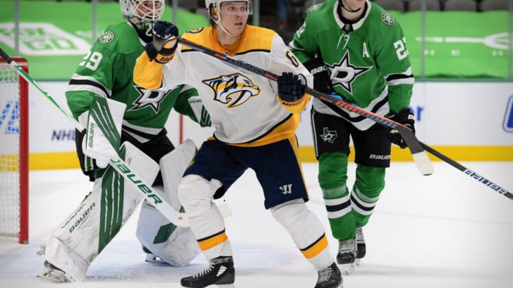 Mar 7, 2021; Dallas, Texas, USA; Dallas Stars goaltender Jake Oettinger (29) and defenseman Esa Lindell (23) defend against Nashville Predators center Mikael Granlund (64) during the third period at the American Airlines Center. Mandatory Credit: Jerome Miron-USA TODAY Sports