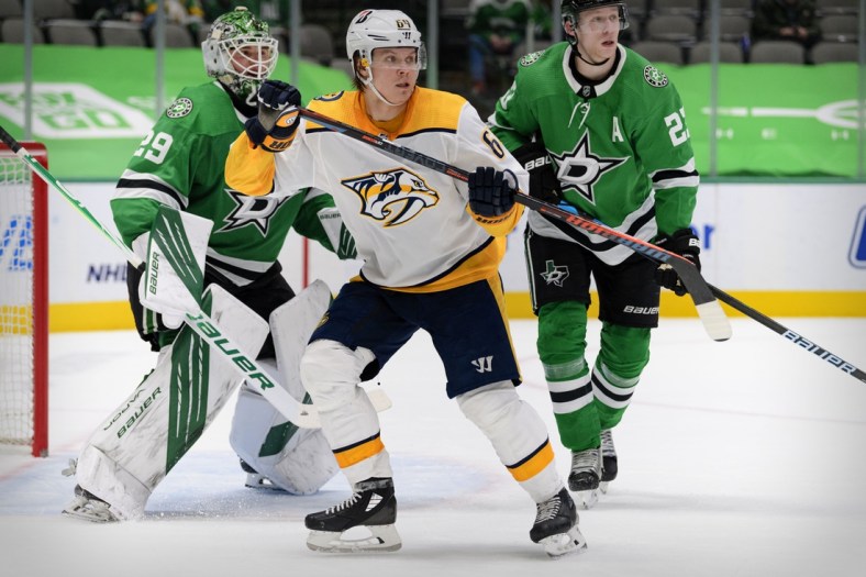 Mar 7, 2021; Dallas, Texas, USA; Dallas Stars goaltender Jake Oettinger (29) and defenseman Esa Lindell (23) defend against Nashville Predators center Mikael Granlund (64) during the third period at the American Airlines Center. Mandatory Credit: Jerome Miron-USA TODAY Sports