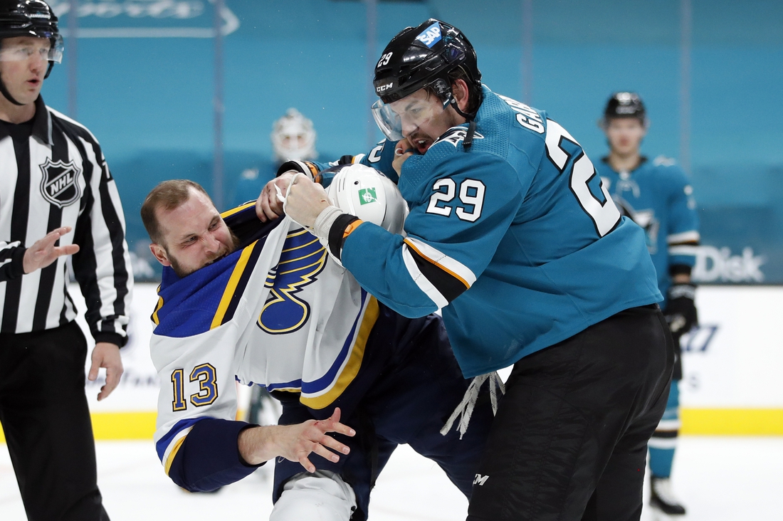 Mar 8, 2021; San Jose, California, USA; St. Louis Blues left wing Kyle Clifford (13) and San Jose Sharks right wing Kurtis Gabriel (29) fight during the first period at SAP Center at San Jose. Mandatory Credit: Darren Yamashita-USA TODAY Sports