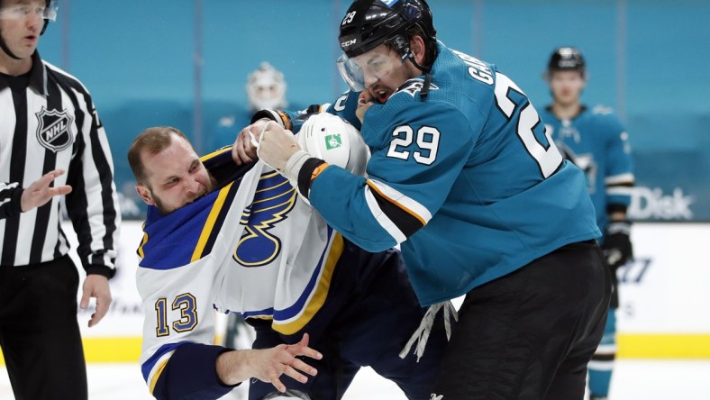 Mar 8, 2021; San Jose, California, USA; St. Louis Blues left wing Kyle Clifford (13) and San Jose Sharks right wing Kurtis Gabriel (29) fight during the first period at SAP Center at San Jose. Mandatory Credit: Darren Yamashita-USA TODAY Sports