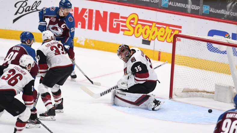 Mar 8, 2021; Denver, Colorado, USA; Arizona Coyotes goaltender Darcy Kuemper (35) allows a goal in the second period against the Colorado Avalanche at Ball Arena. Mandatory Credit: Ron Chenoy-USA TODAY Sports