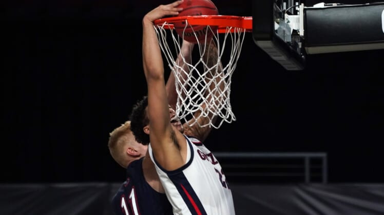 Mar 8, 2021; Las Vegas, NV, USA; Gonzaga Bulldogs forward Anton Watson (22) dunks the ball over St. Mary's Gaels forward Matthias Tass (11) in the second half of a West Coast Conference tournament semifinal at Orleans Arena. Gonzaga defeated St. Mary's 78-52.  Mandatory Credit: Kirby Lee-USA TODAY Sports