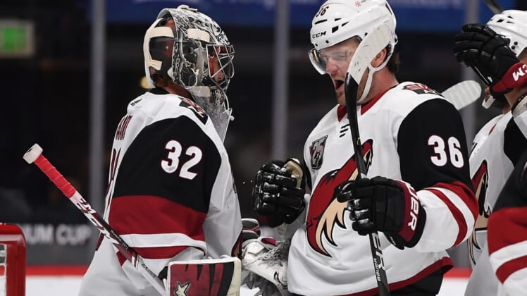 Mar 8, 2021; Denver, Colorado, USA; Arizona Coyotes goaltender Antti Raanta (32) and Arizona Coyotes right wing Christian Fischer (36) celebrate defeating the Colorado Avalanche at Ball Arena. Mandatory Credit: Ron Chenoy-USA TODAY Sports