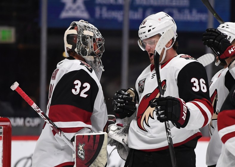 Mar 8, 2021; Denver, Colorado, USA; Arizona Coyotes goaltender Antti Raanta (32) and Arizona Coyotes right wing Christian Fischer (36) celebrate defeating the Colorado Avalanche at Ball Arena. Mandatory Credit: Ron Chenoy-USA TODAY Sports