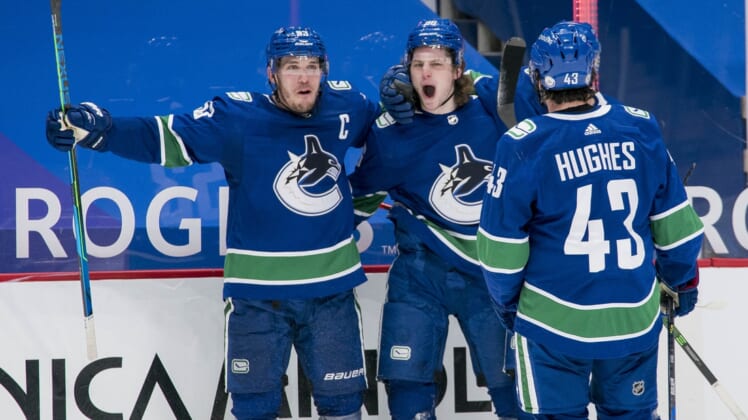 Mar 8, 2021; Vancouver, British Columbia, CAN; Vancouver Canucks forward Bo Horvat (53) and forward Adam Gaudette (96) and  forward J.T. Miller (9) and defenseman Quinn Hughes (43) celebrate Gaudette s goal against the Montreal Canadiens in the third period at Rogers Arena. Canucks won 2-1 in an overtime shootout. Mandatory Credit: Bob Frid-USA TODAY Sports