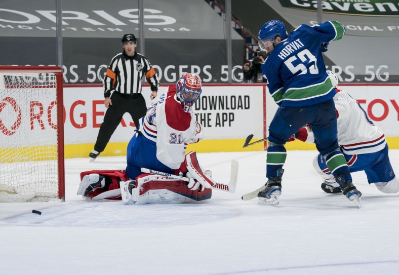 Mar 8, 2021; Vancouver, British Columbia, CAN; Vancouver Canucks forward Bo Horvat (53) and Montreal Canadiens goalie Carey Price (31) watch the rebound in the third period at Rogers Arena. Canucks won 2-1 in an overtime shootout. Mandatory Credit: Bob Frid-USA TODAY Sports