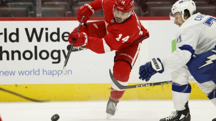 Mar 9, 2021; Detroit, Michigan, USA;  Detroit Red Wings center Robby Fabbri (14) takes a shot in the second period against the Tampa Bay Lightning at Little Caesars Arena. Mandatory Credit: Rick Osentoski-USA TODAY Sports
