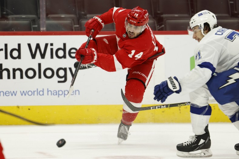 Mar 9, 2021; Detroit, Michigan, USA;  Detroit Red Wings center Robby Fabbri (14) takes a shot in the second period against the Tampa Bay Lightning at Little Caesars Arena. Mandatory Credit: Rick Osentoski-USA TODAY Sports