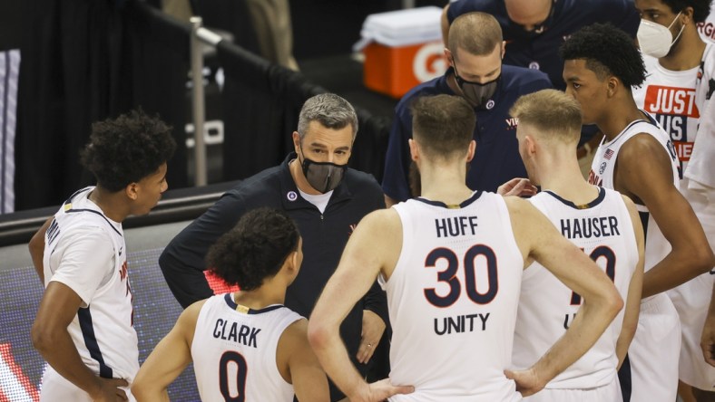 Mar 11, 2021; Greensboro, North Carolina, USA; Virginia Cavaliers head coach Tony Bennett talks to his team during a timeout as his team plays the Syracuse Orange during the second half in the quarterfinal round of the 2021 ACC tournament at Greensboro Coliseum. The Virginia Cavaliers won 72-69.  Mandatory Credit: Nell Redmond-USA TODAY Sports