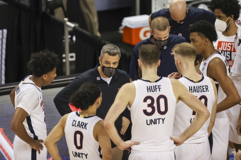Mar 11, 2021; Greensboro, North Carolina, USA; Virginia Cavaliers head coach Tony Bennett talks to his team during a timeout as his team plays the Syracuse Orange during the second half in the quarterfinal round of the 2021 ACC tournament at Greensboro Coliseum. The Virginia Cavaliers won 72-69.  Mandatory Credit: Nell Redmond-USA TODAY Sports