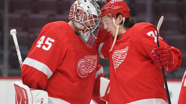 Mar 11, 2021; Detroit, Michigan, USA; Detroit Red Wings goaltender Jonathan Bernier (45) and defenseman Troy Stecher (70) celebrate after the game against the Tampa Bay Lightning at Little Caesars Arena. Mandatory Credit: Tim Fuller-USA TODAY Sports