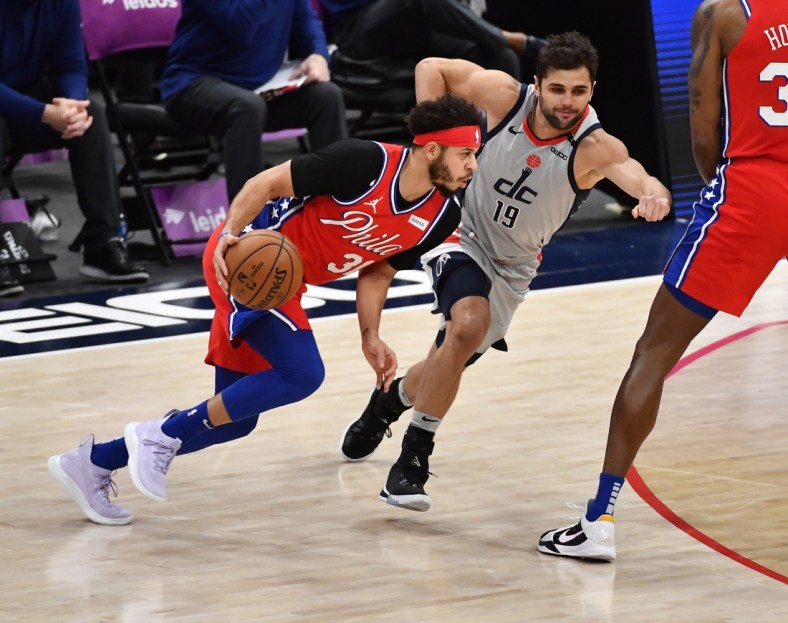 Mar 12, 2021; Washington, District of Columbia, USA; Philadelphia 76ers guard Seth Curry (31) dribbles as Washington Wizards guard Raul Neto (19) chases during the first quarter at Capital One Arena. Mandatory Credit: Brad Mills-USA TODAY Sports