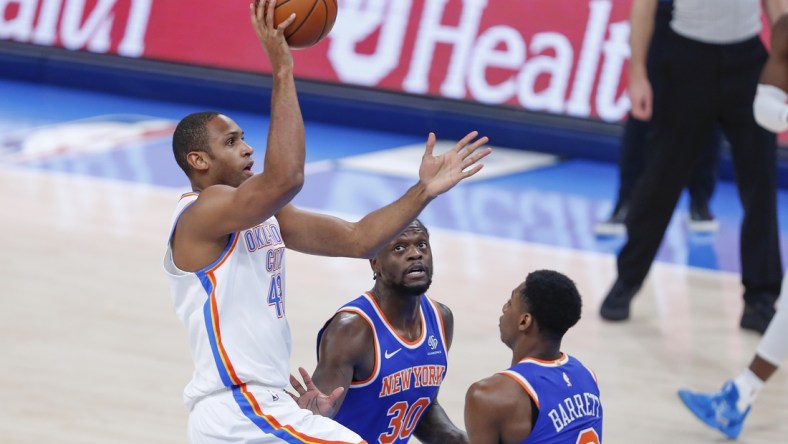 Mar 13, 2021; Oklahoma City, Oklahoma, USA; Oklahoma City Thunder center Al Horford (42) shoots over New York Knicks forward Julius Randle (30) and guard RJ Barrett (9) during the first quarter at Chesapeake Energy Arena. Mandatory Credit: Alonzo Adams-USA TODAY Sports