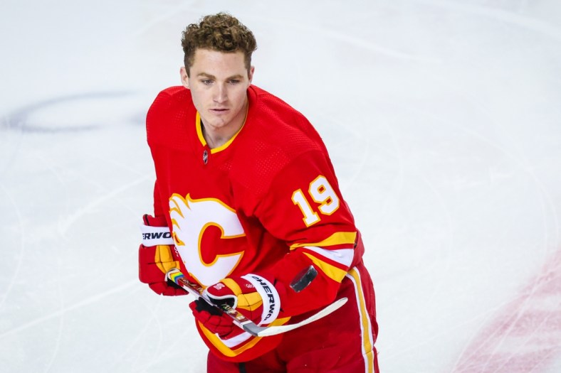 Mar 13, 2021; Calgary, Alberta, CAN; Calgary Flames left wing Matthew Tkachuk (19) controls the puck during the warmup period against the Montreal Canadiens at Scotiabank Saddledome. Mandatory Credit: Sergei Belski-USA TODAY Sports