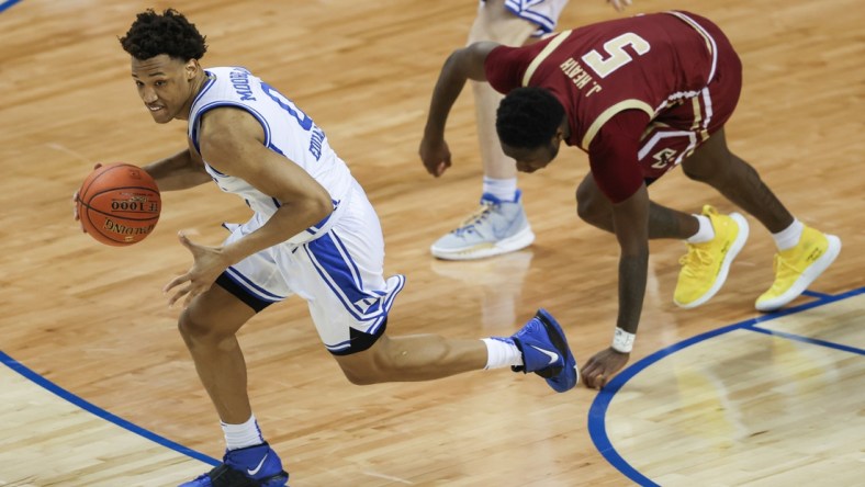 Mar 9, 2021; Greensboro, North Carolina, USA; Duke Blue Devils forward Wendell Moore Jr. (0) pushes the ball upcourt ahead of Boston College Eagles guard Jay Heath (5) in the first round of the 2021 ACC men's basketball tournament at Greensboro Coliseum. Mandatory Credit: Nell Redmond-USA TODAY Sports