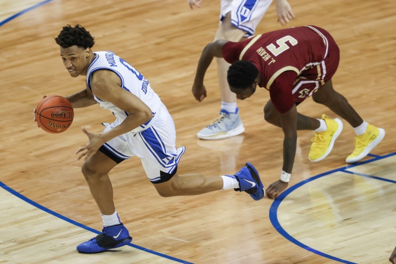 Mar 9, 2021; Greensboro, North Carolina, USA; Duke Blue Devils forward Wendell Moore Jr. (0) pushes the ball upcourt ahead of Boston College Eagles guard Jay Heath (5) in the first round of the 2021 ACC men's basketball tournament at Greensboro Coliseum. Mandatory Credit: Nell Redmond-USA TODAY Sports