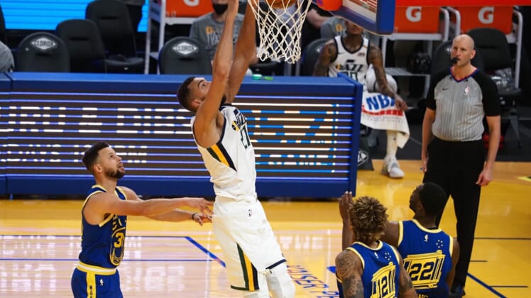 Mar 14, 2021; San Francisco, California, USA; Utah Jazz center Rudy Gobert (27) dunks the ball above Golden State Warriors guard Stephen Curry (30) during the fourth quarter at Chase Center. Mandatory Credit: Kelley L Cox-USA TODAY Sports