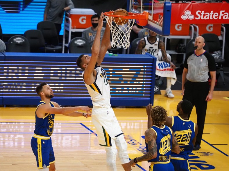 Mar 14, 2021; San Francisco, California, USA; Utah Jazz center Rudy Gobert (27) dunks the ball above Golden State Warriors guard Stephen Curry (30) during the fourth quarter at Chase Center. Mandatory Credit: Kelley L Cox-USA TODAY Sports
