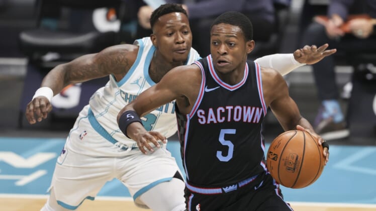 Mar 15, 2021; Charlotte, North Carolina, USA; Sacramento Kings guard De'Aaron Fox (5) drives past Charlotte Hornets guard Terry Rozier (3) during the first quarter at Spectrum Center. Mandatory Credit: Nell Redmond-USA TODAY Sports