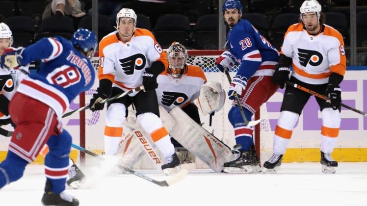Mar 15, 2021; New York, New York, USA; Carter Hart #79 of the Philadelphia Flyers braces for a first period shot from Jacob Trouba #8 of the New York Rangers at Madison Square Garden on March 15, 2021 in New York City.  Mandatory Credit:  Bruce Bennett/POOL PHOTOS-USA TODAY Sports