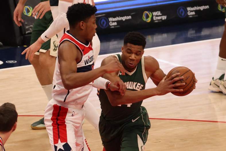 Mar 15, 2021; Washington, District of Columbia, USA; Milwaukee Bucks forward Giannis Antetokounmpo (34) drives to the basket as Washington Wizards forward Rui Hachimura (8) defends in the first quarter at Capital One Arena. Mandatory Credit: Geoff Burke-USA TODAY Sports