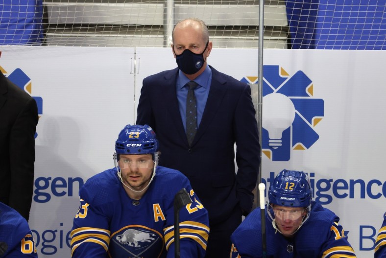 Mar 15, 2021; Buffalo, New York, USA;  Buffalo Sabres head coach Ralph Krueger watches his team play from the bench during the second period against the Washington Capitals at KeyBank Center. Mandatory Credit: Timothy T. Ludwig-USA TODAY Sports