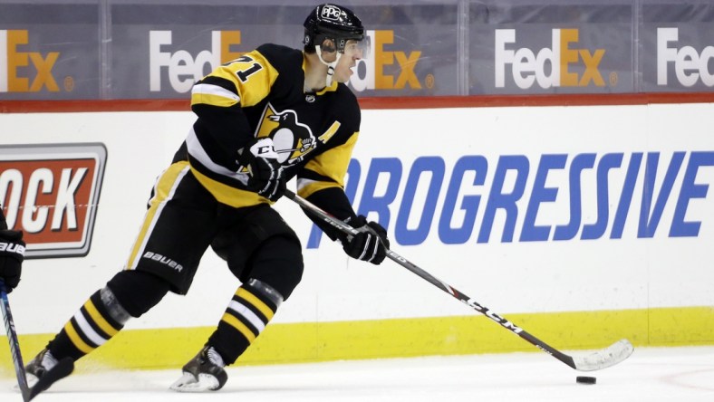 Mar 15, 2021; Pittsburgh, Pennsylvania, USA;  Pittsburgh Penguins center Evgeni Malkin (71) moves the puck against the Boston Bruins during the third period at PPG Paints Arena. Pittsburgh won 4-1 Mandatory Credit: Charles LeClaire-USA TODAY Sports