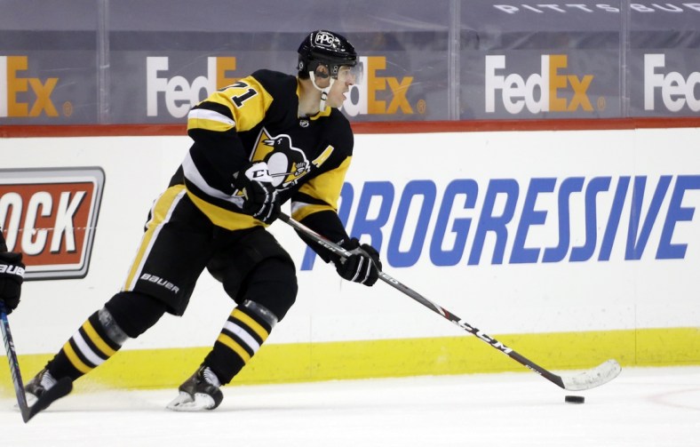 Mar 15, 2021; Pittsburgh, Pennsylvania, USA;  Pittsburgh Penguins center Evgeni Malkin (71) moves the puck against the Boston Bruins during the third period at PPG Paints Arena. Pittsburgh won 4-1 Mandatory Credit: Charles LeClaire-USA TODAY Sports