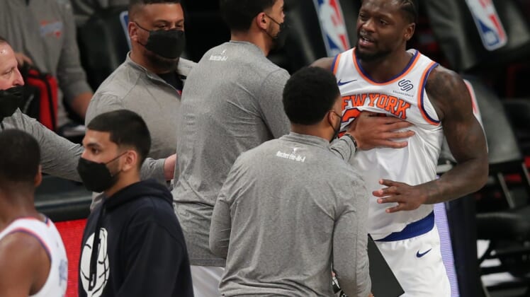 Mar 15, 2021; Brooklyn, New York, USA; New York Knicks power forward Julius Randle (30) is restrained by coaches and players after being called for a travel at the end of the game against the Brooklyn Nets at Barclays Center. Mandatory Credit: Brad Penner-USA TODAY Sports